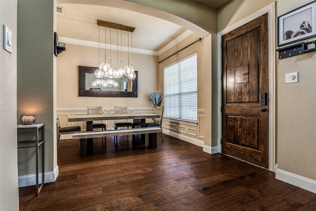 dining room featuring wood-type flooring, a chandelier, and ornamental molding