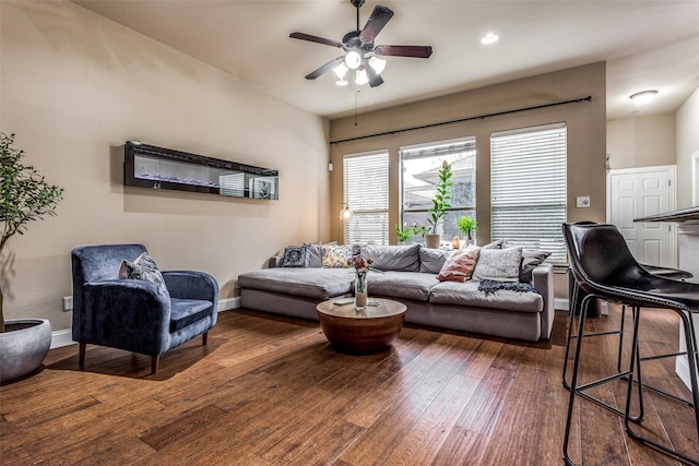 living room with ceiling fan and dark hardwood / wood-style floors