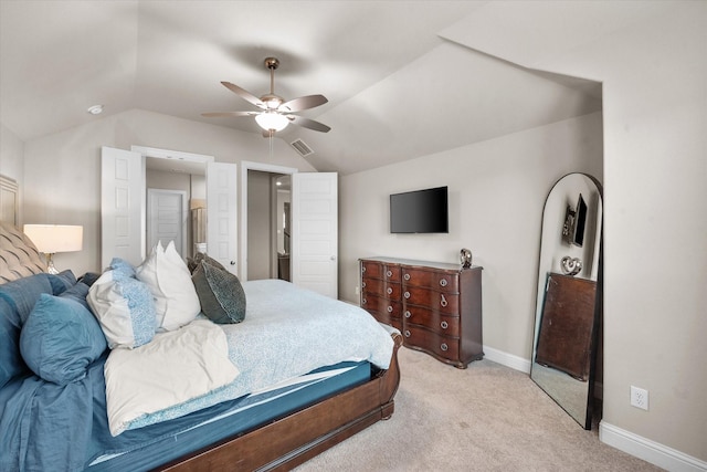 bedroom with ceiling fan, light colored carpet, and lofted ceiling