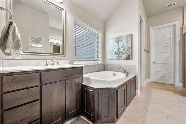 bathroom featuring lofted ceiling, tile patterned flooring, vanity, and a bath