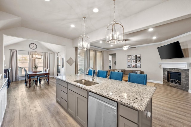 kitchen with sink, gray cabinetry, an island with sink, and dishwasher