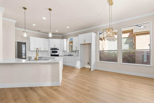 kitchen featuring white cabinets, a healthy amount of sunlight, and sink