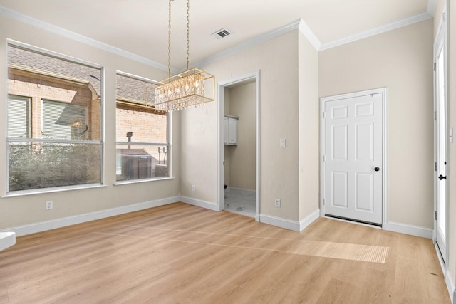 unfurnished dining area with a chandelier, ornamental molding, and light hardwood / wood-style flooring