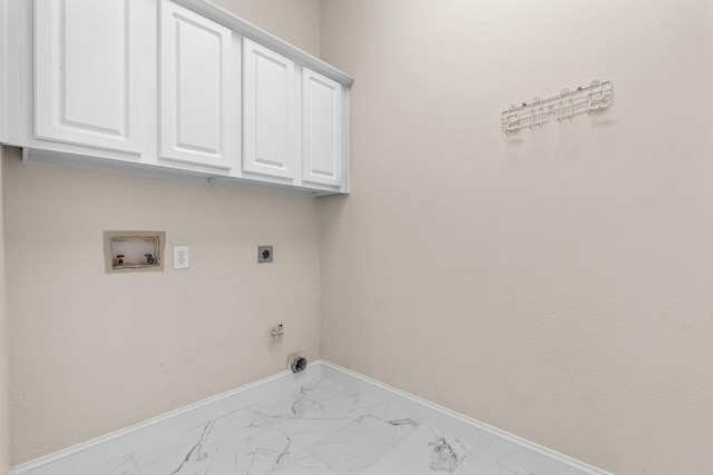 washroom featuring hookup for a gas dryer, washer hookup, cabinets, and hookup for an electric dryer