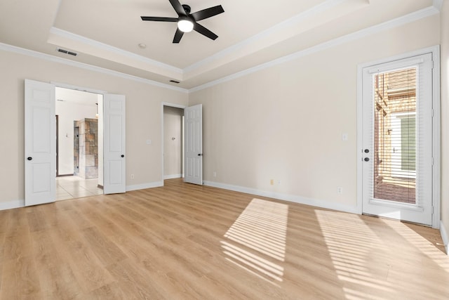 unfurnished bedroom with ceiling fan, a tray ceiling, and crown molding