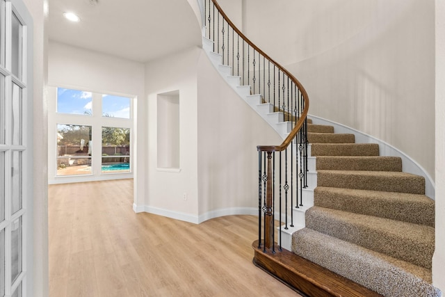 stairs with hardwood / wood-style floors