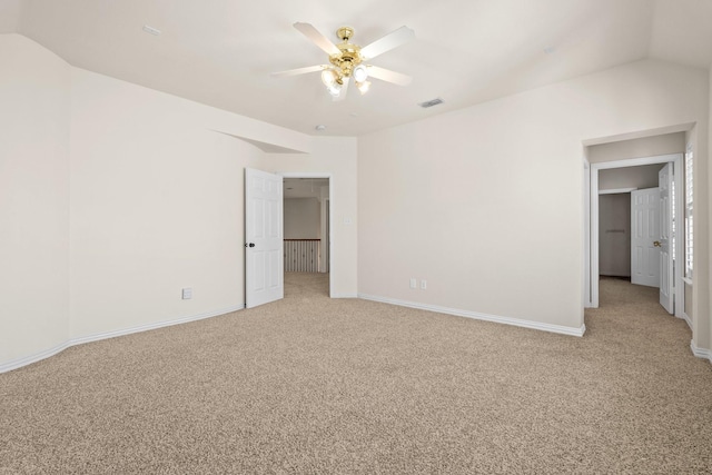 unfurnished bedroom with ceiling fan, vaulted ceiling, and light colored carpet