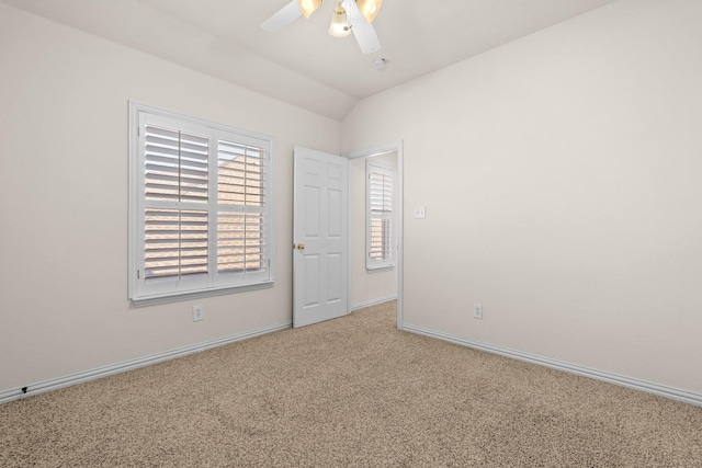 carpeted empty room with lofted ceiling and ceiling fan