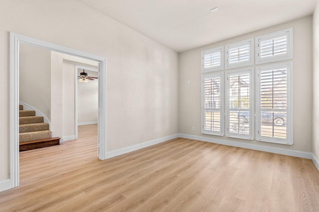 spare room featuring ceiling fan and light hardwood / wood-style flooring