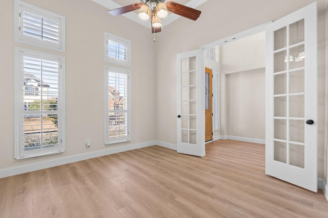 spare room featuring ornamental molding, light wood-type flooring, ceiling fan, and french doors