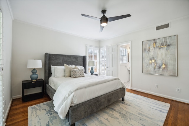 bedroom featuring ensuite bath, ceiling fan, ornamental molding, and dark wood-type flooring