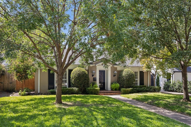 obstructed view of property featuring a front lawn