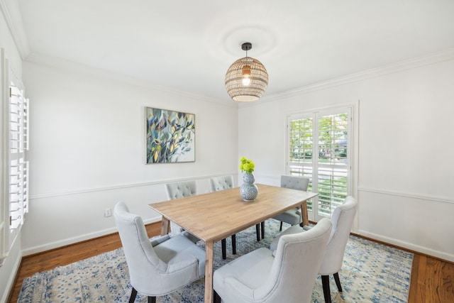 dining area with crown molding and wood-type flooring