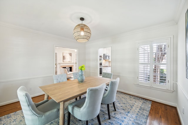 dining space with crown molding and dark hardwood / wood-style floors