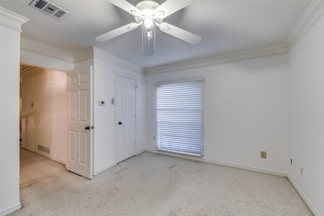 unfurnished room featuring ornamental molding, carpet, and visible vents