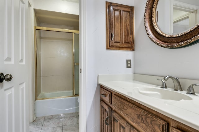 bathroom with bath / shower combo with glass door and vanity