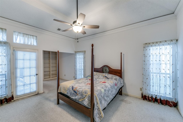 carpeted bedroom featuring visible vents, multiple windows, a ceiling fan, and crown molding