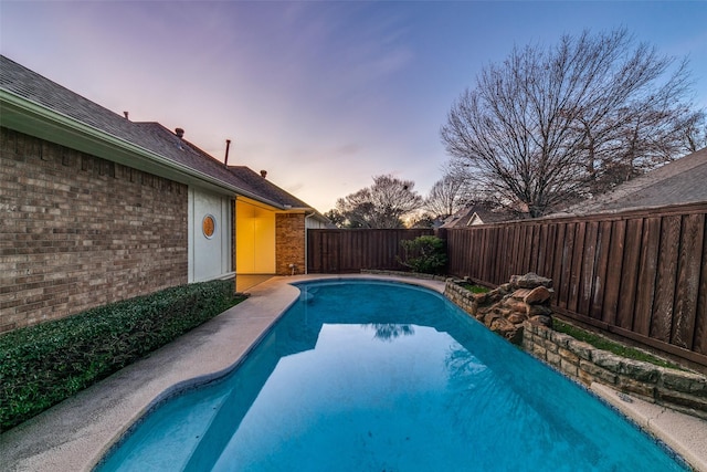 view of swimming pool with a fenced backyard and a fenced in pool