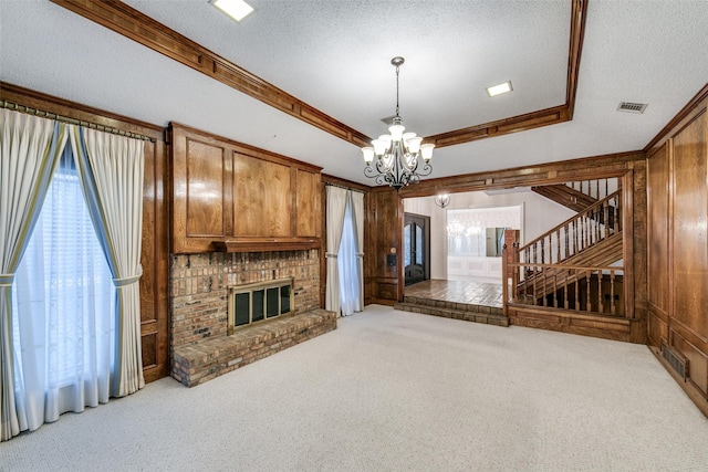 living area featuring carpet floors, a wealth of natural light, a brick fireplace, and visible vents