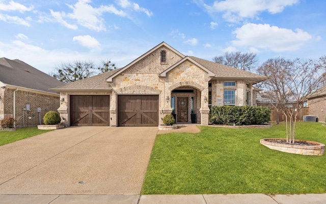 view of front of home with a front lawn and a garage