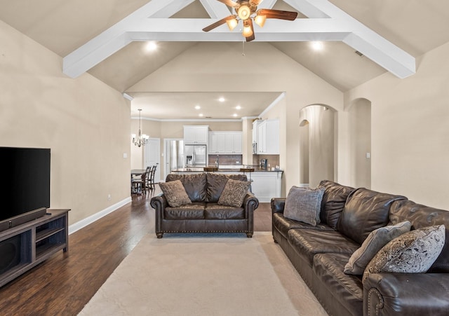 living room featuring vaulted ceiling with beams, ceiling fan with notable chandelier, and hardwood / wood-style flooring