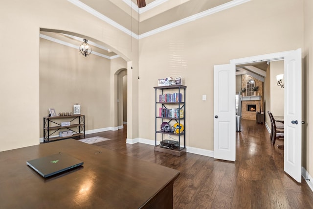 home office with a high ceiling, a fireplace, and dark hardwood / wood-style flooring