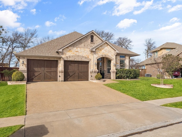 view of front of property with a front yard and a garage