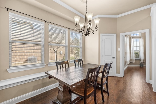 dining space with a chandelier, a healthy amount of sunlight, crown molding, and dark hardwood / wood-style floors