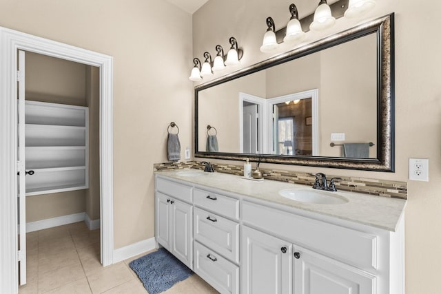 bathroom with tile patterned flooring, decorative backsplash, and vanity