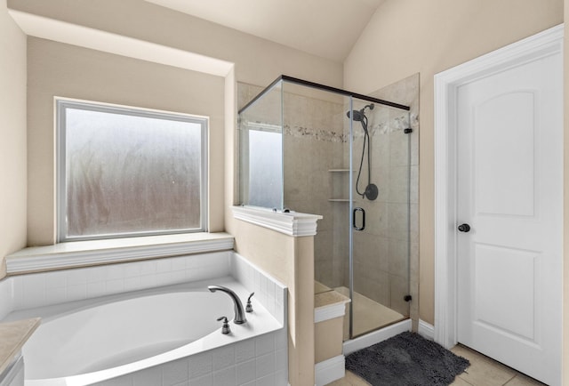 bathroom featuring tile patterned floors, a wealth of natural light, vaulted ceiling, and plus walk in shower