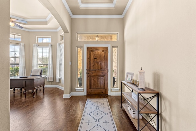 entrance foyer with ceiling fan, dark wood-type flooring, a towering ceiling, and crown molding