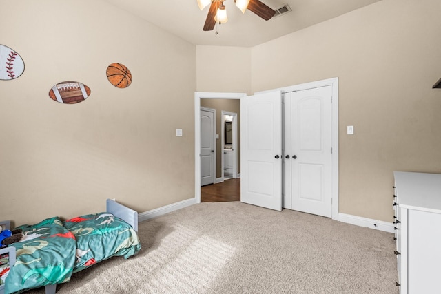 unfurnished bedroom with carpet floors, ceiling fan, and a closet