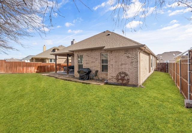 rear view of property featuring a lawn and a patio area