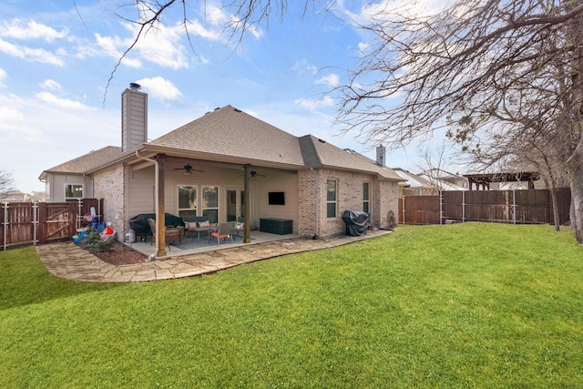 back of house featuring a lawn, a patio area, ceiling fan, and an outdoor living space