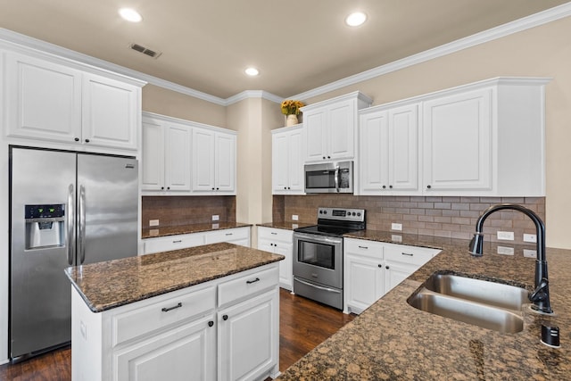 kitchen featuring sink, white cabinets, tasteful backsplash, and appliances with stainless steel finishes