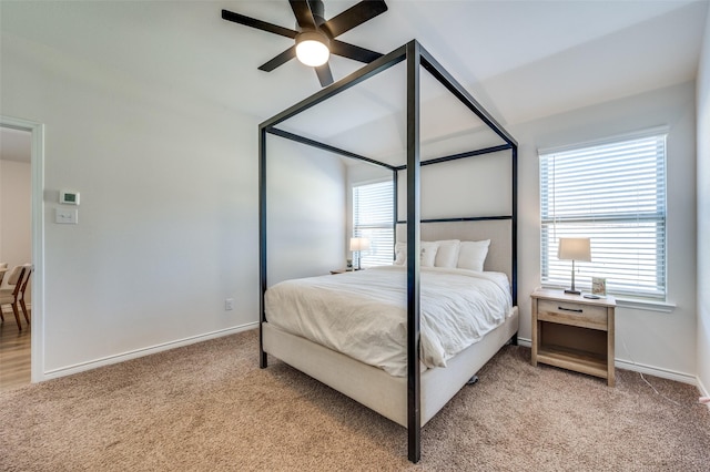 bedroom with ceiling fan, light carpet, and multiple windows