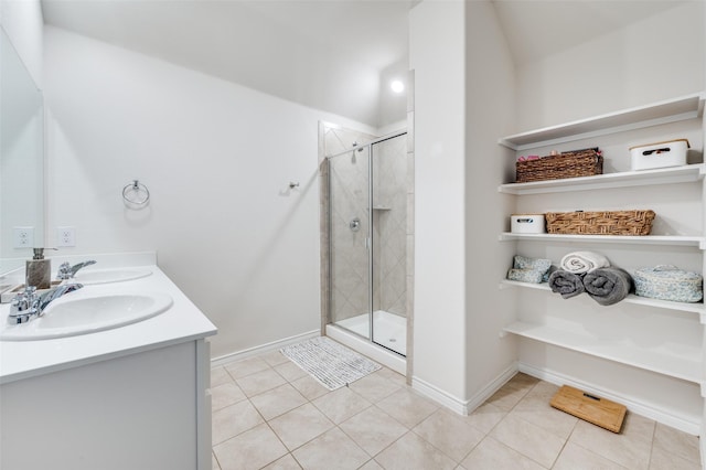 bathroom with walk in shower, vanity, and tile patterned floors