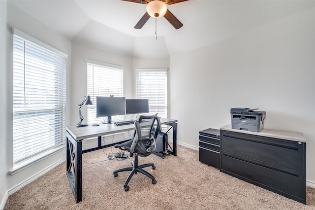 office featuring lofted ceiling, ceiling fan, and light carpet