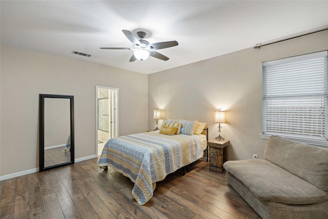 bedroom featuring ensuite bath, ceiling fan, and dark hardwood / wood-style floors