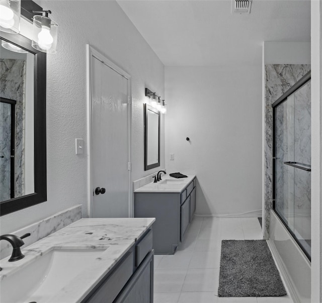 bathroom with vanity, tile patterned flooring, and combined bath / shower with glass door