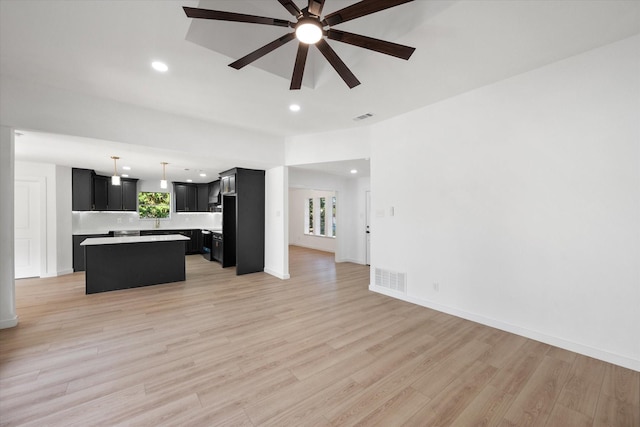 unfurnished living room with ceiling fan and light hardwood / wood-style floors