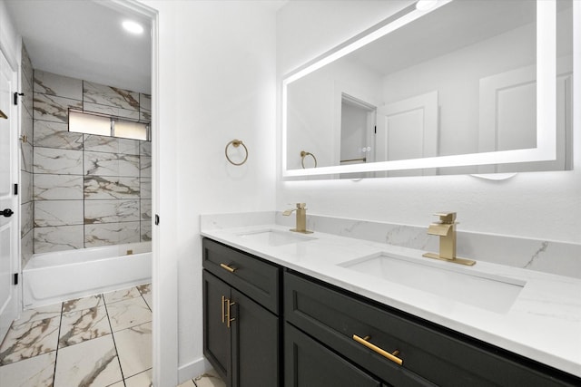 bathroom featuring vanity and tiled shower / bath