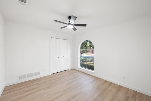 empty room featuring ceiling fan and light hardwood / wood-style flooring