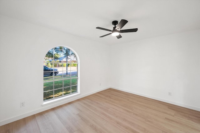 unfurnished room with ceiling fan, light hardwood / wood-style flooring, and a wealth of natural light