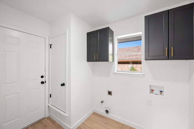 clothes washing area with washer hookup, electric dryer hookup, light wood-type flooring, cabinets, and gas dryer hookup