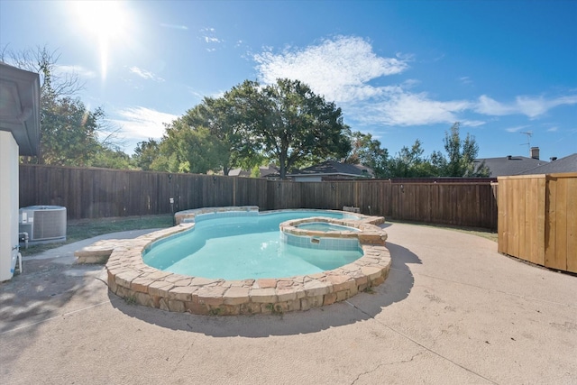 view of swimming pool featuring a patio, cooling unit, and an in ground hot tub