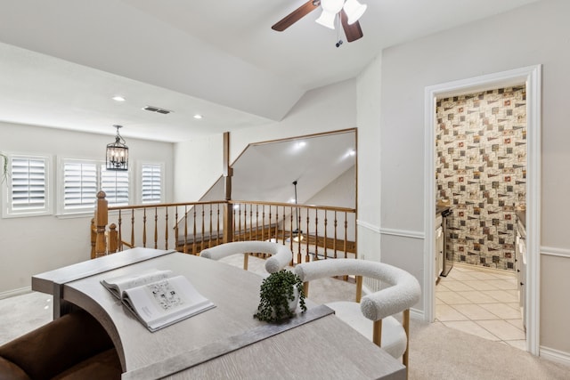 interior space featuring lofted ceiling and ceiling fan with notable chandelier