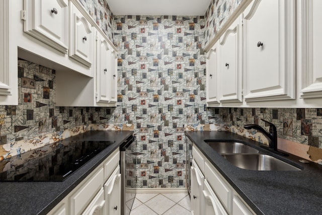 kitchen with sink, black electric cooktop, light tile patterned floors, and white cabinetry