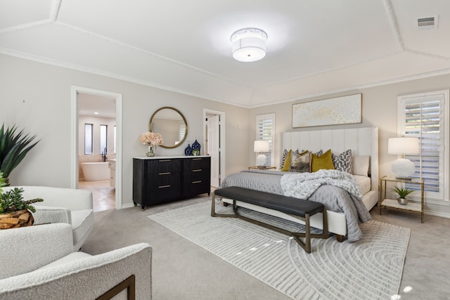 bedroom featuring crown molding, connected bathroom, multiple windows, and carpet