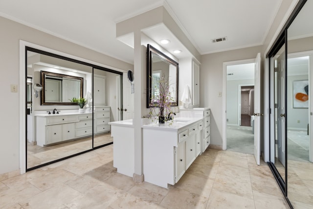 bathroom with crown molding and vanity